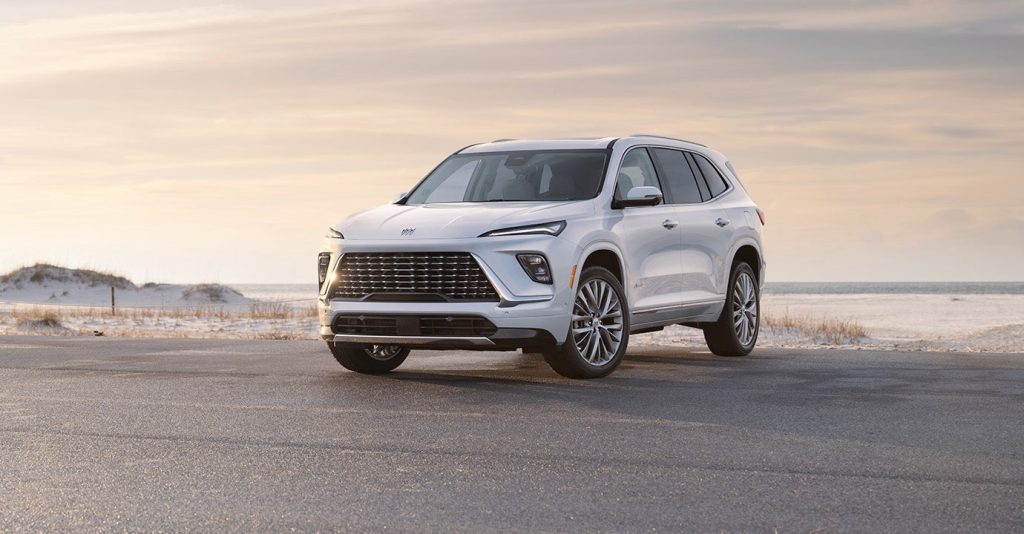 White 2025 Buick Enclave parked in front of an East Coast Beach